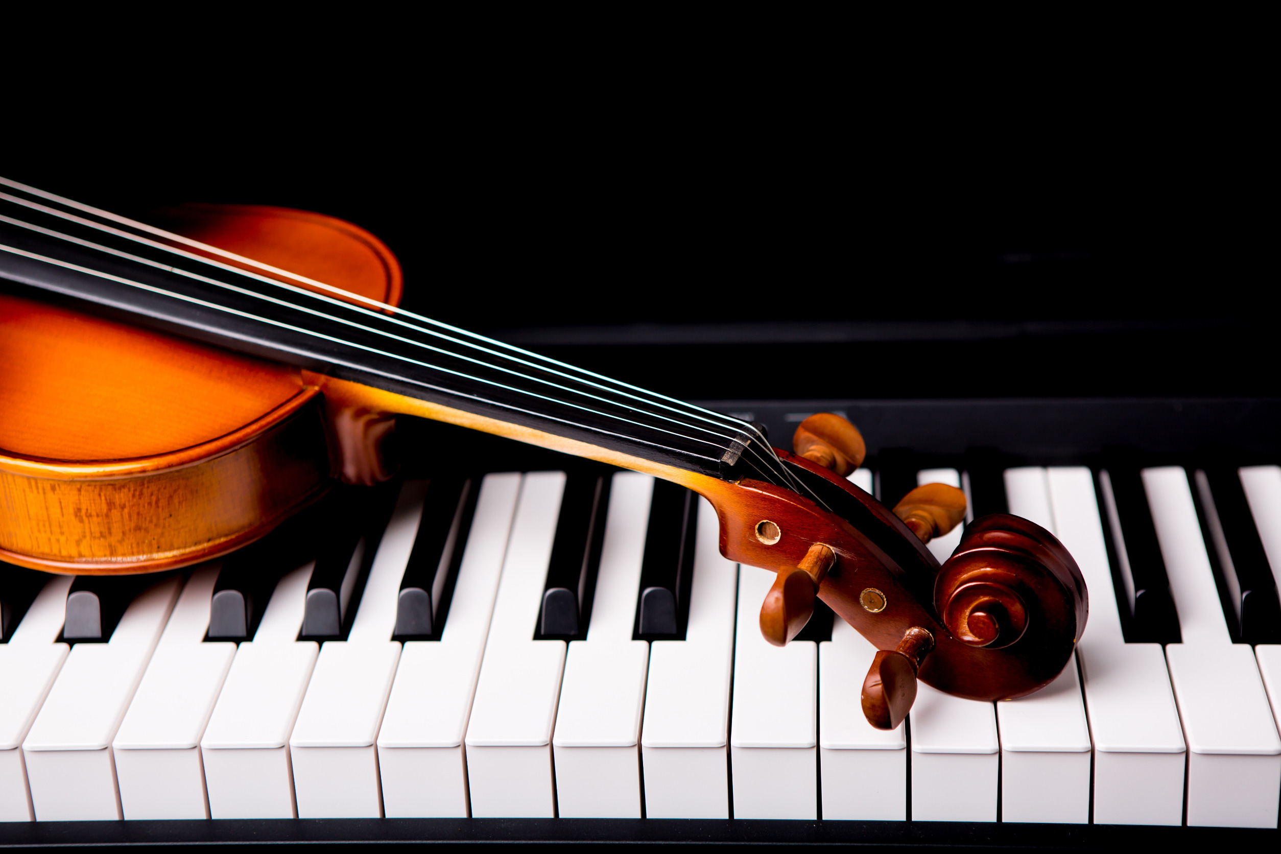 Violin laying on piano