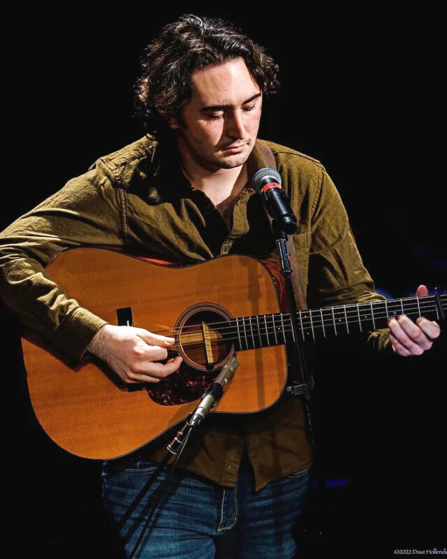 Musician playing acoustic guitar